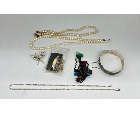 A selection of costume jewellery to include pearl necklace, silver bangle etc