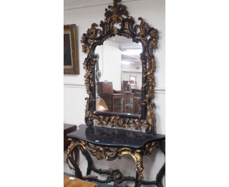 An ornate black and gilt console table, 83cm high x 130cm wide x 53cm deep and mirror, 165cm high x 110cm wide (2) Condition 