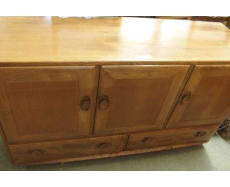 An Ercol sideboard with three doors over two drawers, 76cm high x 130cm wide x 45cm deep Condition Report: Available upon req