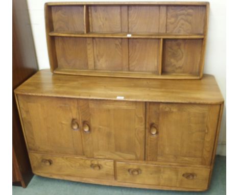 An Ercol sideboard with three doors over two drawers, 76cm high x 130cm wide x 48cm deep and a wall rack (2) Condition Report