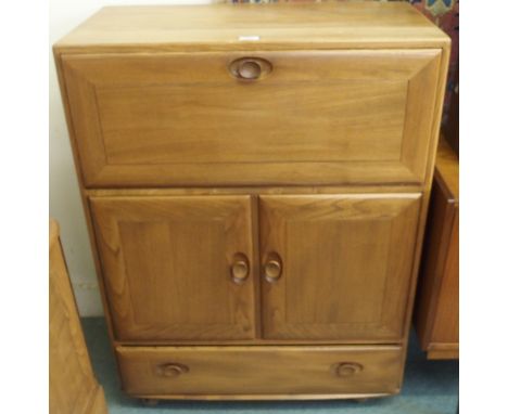 An Ercol cabinet with drop front, two doors over single drawer, 110cm high x 82cm wide x 44cm deep Condition Report: Availabl