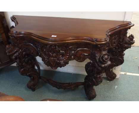 A reproduction carved mahogany console table, 82cm high x 138cm wide x 52cm deep Condition Report: Available upon request