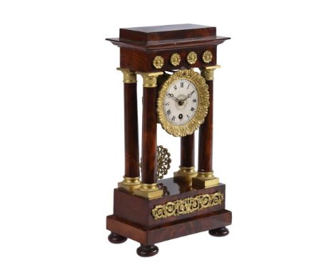 A FRENCH CHARLES X ORMOLU MOUNTED MAHOGANY MINIATURE PORTICO MANTEL TIMEPIECEUnsigned, probably Paris, circa 1830The circular