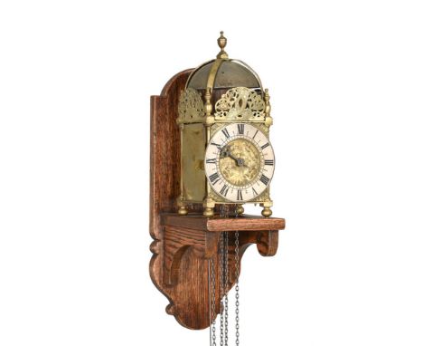 A BRASS LANTERN CLOCKThe dial engraved with initials B.H., probably mid 20th century incorporating earlier elementsThe countw