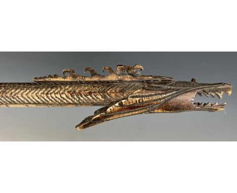 A carved bone blow pipe, in the form of a dragon, probably from Borneo, 82 cm 