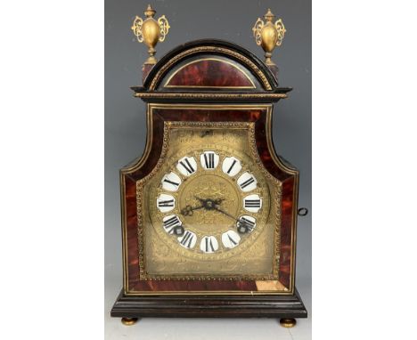 A mantel clock, with a gilt metal and enamel dial, striking on a bell, in a tortoiseshell ebonised and gilt metal case, 30 cm