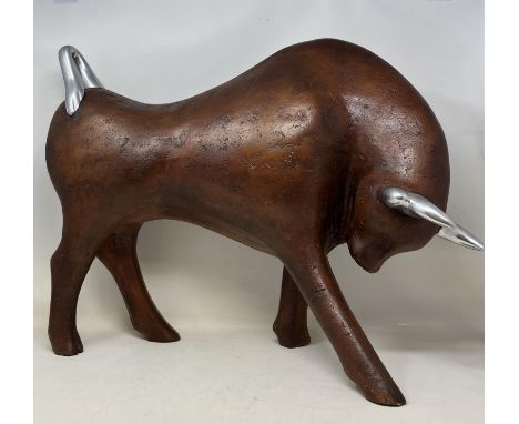 A modern figure of a bull, assorted African carvings, and a Continental silver coloured metal tea caddy, in the form of a pea