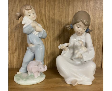Vintage Nao figure of a girl feeding a lamb and a Nao figure of a girl cuddling a Lamb, tallest measures 18cm tall 