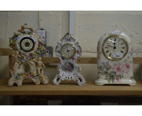 THREE MANTEL CLOCKS IN CERAMIC CASES