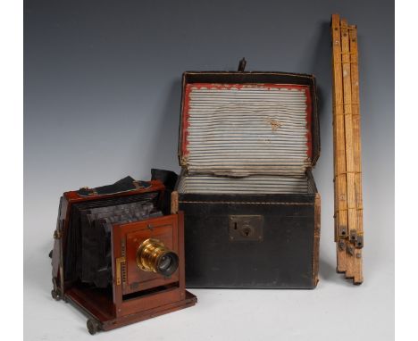An early 20th century 1/4 plate folding bellows camera, by Wray of London, mahogany body, black bellows 6 3/4/5 lense, oak tr