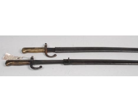 A French Chassepot sword bayonet, 57.5cm curved fullered blade, curved quillon, brass grip, no.485440, steel scabbard, 70.5cm