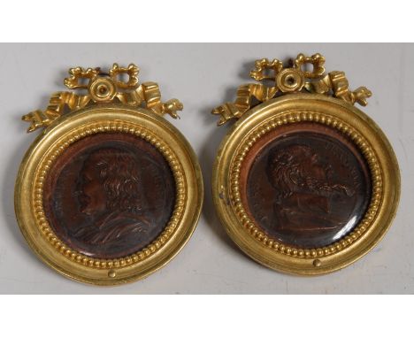 A pair of 19th century portrait medallions, Nicholas Poussin and Pierre Jeannin, 4.5cm diam, gilt frames with ribbon cresting