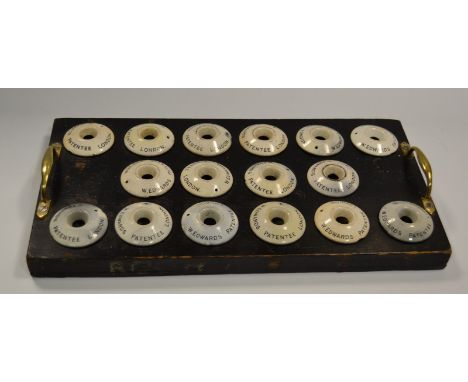 W Edwards Patentee - a set of sixteen white ceramic inkwells, each inscribed in black, fitted into a two handled rectangular 