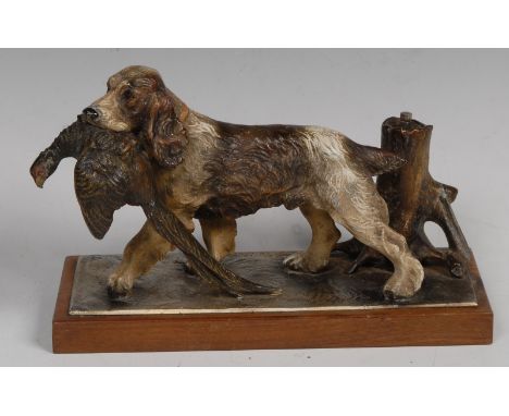 An Austrian cold painted novelty table lighter, cast as a springer spaniel retrieving a pheasant, rectangular wooden base, 25