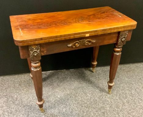 A 19th century flame mahogany games table, rounded rectangular fold over top, green baize playing surface, 74cm high, 91cm wi