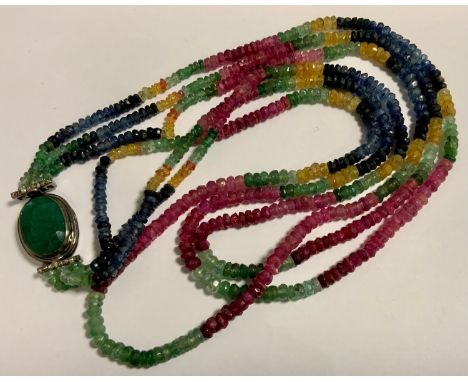 A sapphire, emerald and ruby rough cut beaded triple row necklace, oval emerald clasp, silver colored metal clasp, 42cm long 