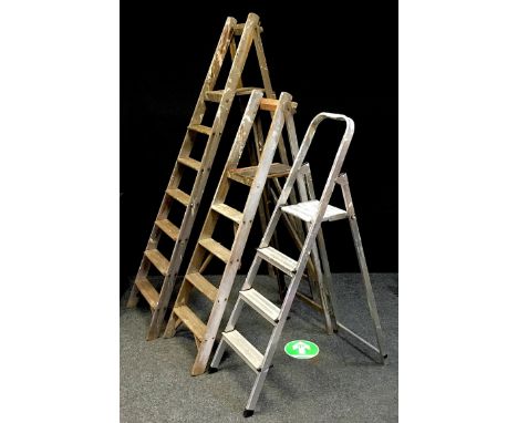 Two vintage wooden stepladders; another aluminium. (3) 