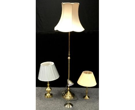 A brass standard lamp; two brass table lights; an Anglepoise style LED desk lamp. (4) 