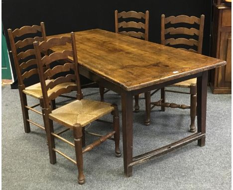 A country oak plank top table (77cm high x 88cm wide x 203cm long), four rush seated ladder back chairs (5). 