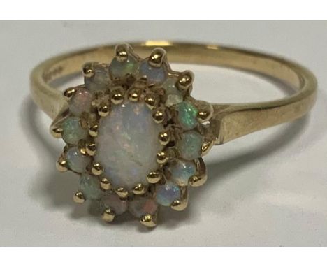 A 9ct gold oval opal cluster ring, size P, London 1970, 2.2g gross 