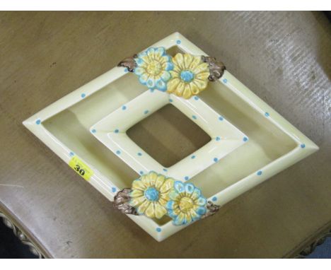 A Clarice Cliff, Wilkinson Pottery diamond shaped, Bizarre posy bowl decorated with two groups of daisy flower heads in shall