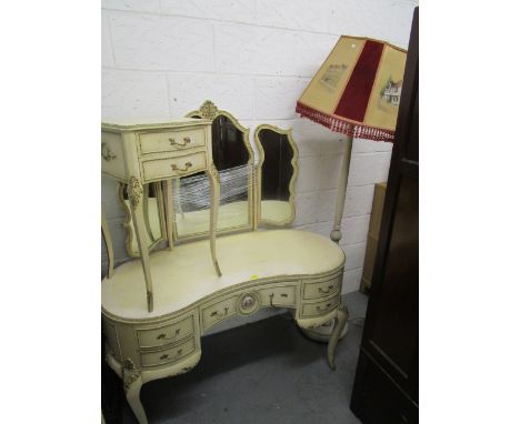 A French white painted bedroom suite, circa 1950, comprising a serpentine fronted chest of five drawers on knee carved and gi