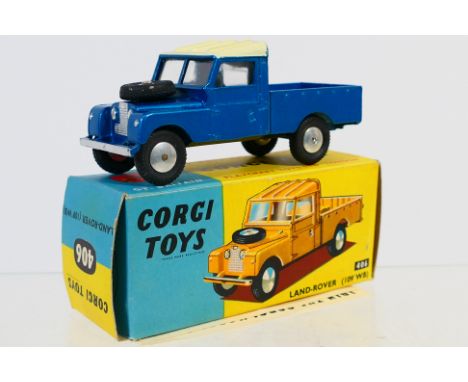 Corgi - A boxed Land Rover 109' WB pick up in metallic blue with white roof # 406. The model appears Mint in a Very Good box 