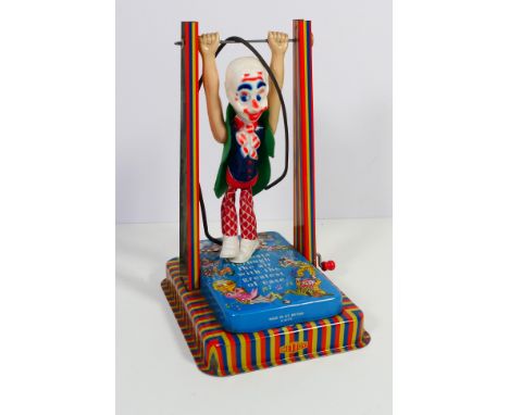 Mettoy - A boxed Mettoy #6174 'Musical Man on a Trapeze'. The toy has a a snapped pulley string and would benefit from a symp