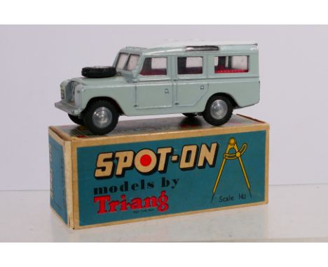 Spot-On - A boxed Tri-ang Spot-On #161 LWB Land Rover. The model in grey with white roof, red interior and spun hubs, has som
