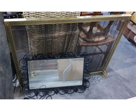 Brass-coloured metal spark guard with draw back wire curtains and a mirror with wrought iron surround, showing vine leaves (2