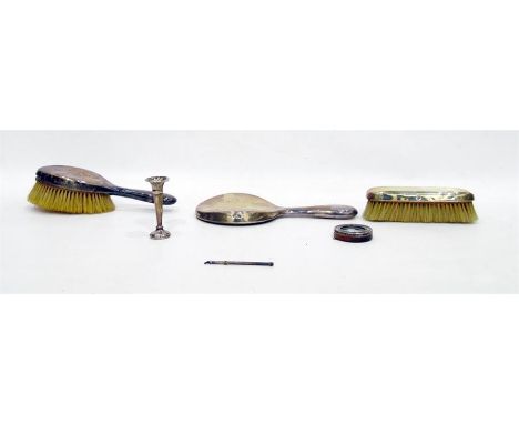 Early 20th century three-piece silver-mounted dressing set comprising of two brushes and a mirror, of plain form (dented) (ma