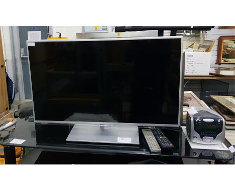 Panasonic flatscreen television with black glass and chrome television stand, a Compacks Kodak DVD player and a Roberts Dual 