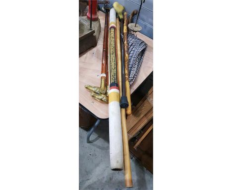 Various modern brass and wood walking sticks, two with horse head handles, a didgeridoo, a Burberry umbrella and other walkin