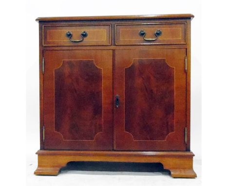 Reproduction mahogany veneer cupboard with moulded edge top, two frieze drawers, the pair of panelled doors enclosing shelf, 