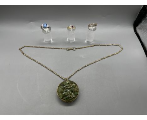 Stone Cluster Locket on Chain, One 9ct gold Band ring, One 18ct Central Red Gemstone Ring, One Silver Blue Stone Ring