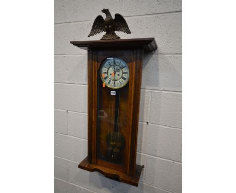 A LATE VICTORIAN WALNUT VIENNA EIGHT DAY WALL CLOCK, with papier Mache eagle pediment, enamel dial with roman numerals and se