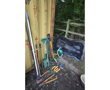 A QUANTITY OF GARDEN TOOLS, to include spades, forks, rakes, hedge cutters, etc, along with a small plastic garden pond and h