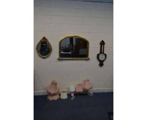 AN EDWARDIAN MAHOGANY ANEROID BAROMETER, a modern gilt overmantel mirror, a foliate gilt on plaster oval wall mirror, two bra