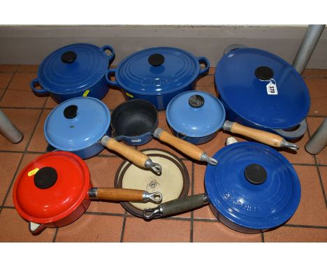 A COLLECTION OF MOSTLY BLUE LE CREUSET ENAMELLED CAST IRON COOKWARE AND OTHER FRENCH CAST IRON SAUCEPANS AND CASSEROLE DISHES