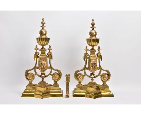 A PAIR OF BRASS FENDER ENDS with lions head motifs, height 45cm, paired with a Victorian brass grandfather clock door knocker