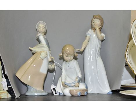 THREE NAO BY LLADRO FIGURINES, comprising a small girl holding a doll, approximate height 16cm, a young woman holding a baske