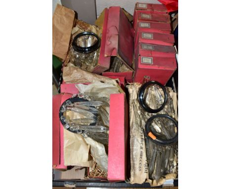 APPROXIMATELY TWENTY BOXED AND LOOSE GLASS LAMP LUSTRES, each with a circular metal frame with either facet or ribbed dropper