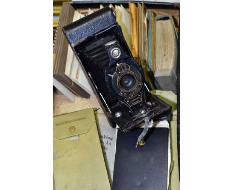 A KODAK NO.2A FOLDING AUTOGRAPHIC BROWNIE CAMERA, in distressed condition, with an old leather suitcase containing a collecti