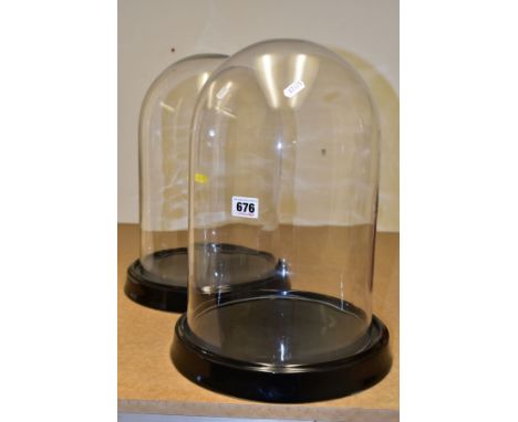 A PAIR OF MODERN DISPLAY GLASS DOMES on black glazed ceramic bases, height excluding bases approximate 37cm, internal diamete