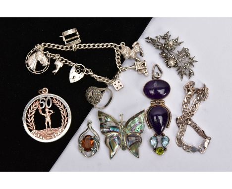 A BAG OF SILVER AND WHITE METAL ITEMS, to include a silver charm bracelet, suspending six charms such as a dice, horseshoe, w