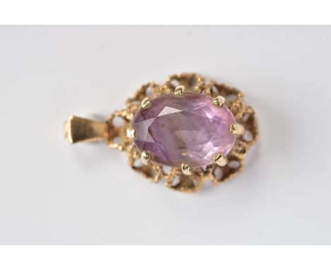 A 9CT GOLD AMETHYST PENDANT, of an oval form, claw set oval cut amethyst, within an openwork rope twist surround, hallmarked 
