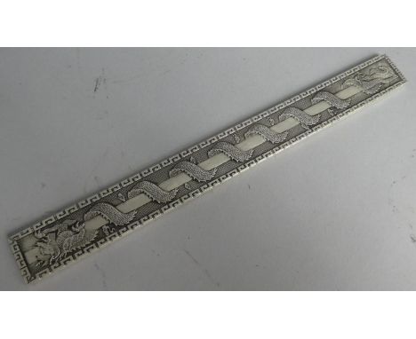 A Chinese White Metal Scroll Weight with Dragon Decoration, Signed to Back, 23cm Wide 