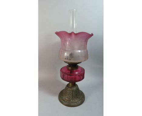 A Late Victorian Brass Based Oil Lamp With Cranberry Glass Reservoir, Hinks Duplex Controls and Etched Cranberry Glass Shade,