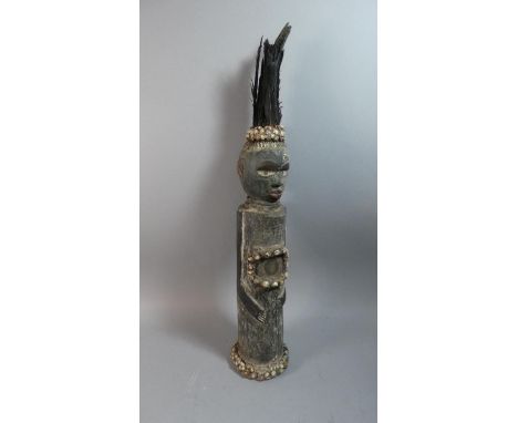 A Coastal Tribal Carved Wooden Figure Decorated with Shells and Feathers, 65cm High 