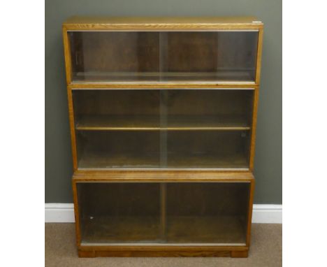 Mid 20th century oak stepped library style bookcase, two compartments with sliding glazed doors, plinth base (W89cm, H77cm, D